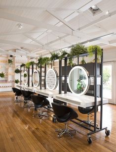 an empty salon with chairs and mirrors on the wall next to eachother's desks