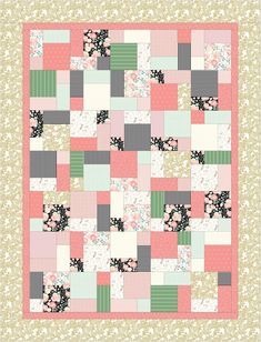 a pink and green patchwork quilt with flowers on it's border, in the middle