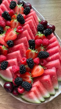 watermelon slices and blackberries arranged on a platter