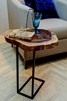 a table with a glass and book on it in front of a couch or chair