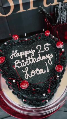 a heart shaped birthday cake on a table