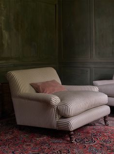 a striped chair and footstool in a room