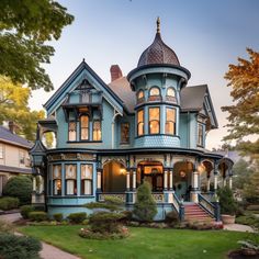 a blue victorian style house with many windows