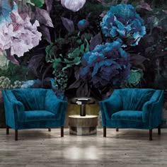 two blue chairs in front of a floral wall mural