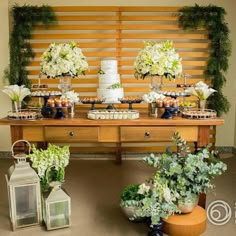 a table topped with lots of cakes and flowers