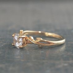 a gold ring with a white diamond on it