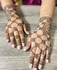 two hands with henna designs on them