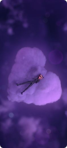 an image of a purple sky with clouds and a person in the air holding onto a pair of scissors