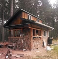 there is a small cabin in the woods with wood and stone on it's sides