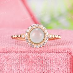 a close up of a ring on a pink surface