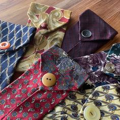 many different colored ties with buttons on them