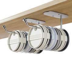 three circular pans are hanging from the ceiling and two hangers on each side