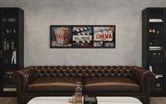 a brown leather couch sitting in front of a book shelf next to a white table