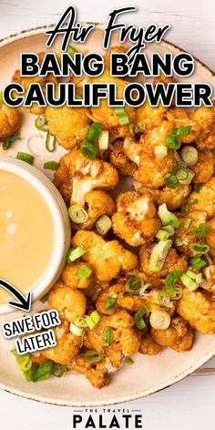 a plate filled with cauliflower next to a bowl of dipping sauce on the side