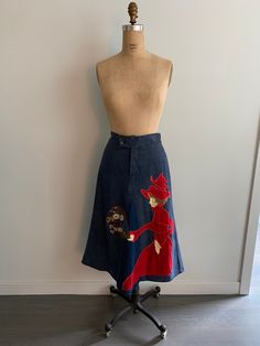 a mannequin wearing a skirt with an image of a woman on the front