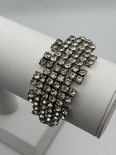 A glorious crystal evening cuff. The design is as fascinating as it is beautiful.  Excellent vintage condition, with all crystals shiny and present. The outer circumference measures approx 17cm, and the width is 3cm.  Clean and ready to wear. -------------------- 🌟 P&P: 👉 Will arrive gift wrapped, in a padded bag. 👉 UK shipping: Royal Mail Tracked 24 👉 International Shipping: Royal Mail International Tracked -------------------- 💎 FOLLOW US:  👉 www.instagram.com/janedreamsofvintage 👉 www. Geometric Crystal, Padded Bag, Crystal Cuff Bracelet, Pad Bag, 50s Vintage, Wedding Jewelry Bracelets, Black Leather Bags, Drawstring Pouch, Christmas Paper