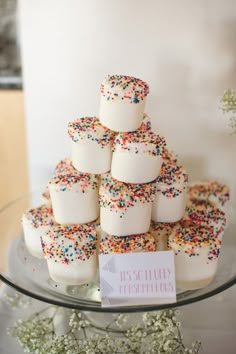 a cake with sprinkles on it sitting on a table