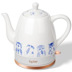 a white tea pot with blue cats on it