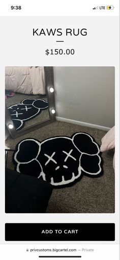 a black and white rug with a skull on it, in front of a mirror