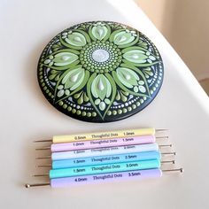 four different colored toothbrushes sitting on top of a white surface next to each other