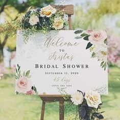 a sign with flowers on it that says welcome to bridal shower