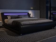 a bedroom with a large bed and two night lights on the side of the bed