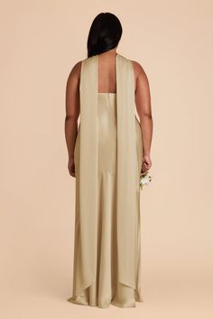 the back of a woman in a beige dress