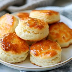 small biscuits on a white plate sitting on a table