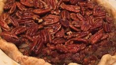 a pie with pecans in it sitting on a table