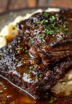 some meat and mashed potatoes on a plate