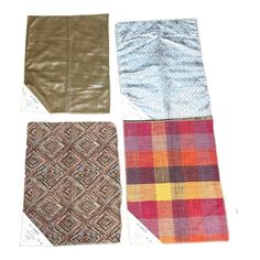 four pieces of cloth laid out on top of each other in different colors and patterns