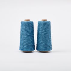 two spools of thread on white background