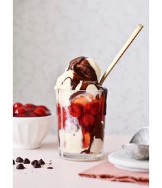 an ice cream sundae with strawberries and chocolate