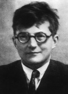 an old black and white photo of a man wearing glasses