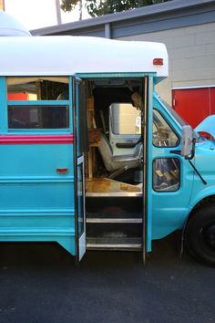 an old blue bus with its door open