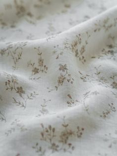 the fabric is white with brown flowers on it