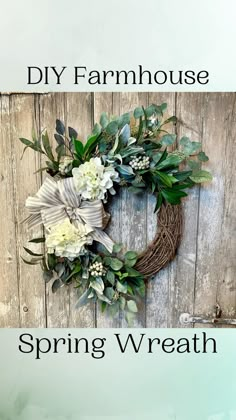 a wreath hanging on the side of a wooden door with flowers and greenery in it