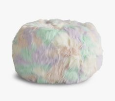 a multicolored poufce sits on a white surface