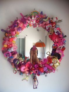 a person taking a selfie in front of a mirror with toys all over it