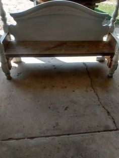 a white bench sitting on top of a cement floor