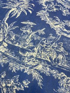 a blue and white table cloth with an image of people in the woods on it