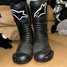 a pair of black and white boots sitting on top of a couch