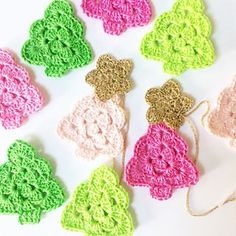 crocheted ornaments are arranged on a white surface