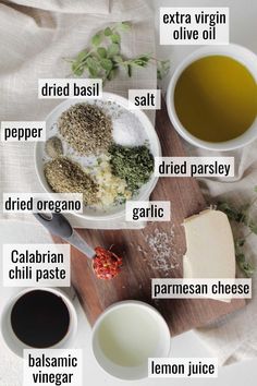 the ingredients to make this recipe are displayed on a wooden cutting board, including olives, parmesan cheese, and extra virgin oil