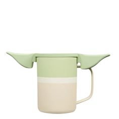 a green and white coffee cup with two handles