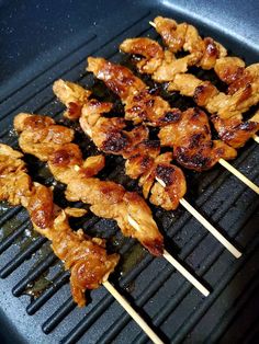 several skewers of chicken on a grill with toothpicks sticking out of them