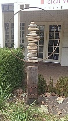 a sculpture made out of rocks in front of a building