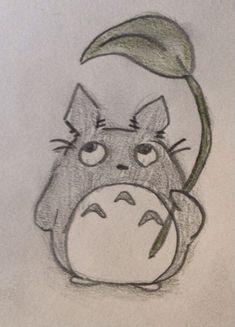 a drawing of a totoro with a leaf on its head