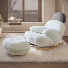 a white chair and ottoman in a living room