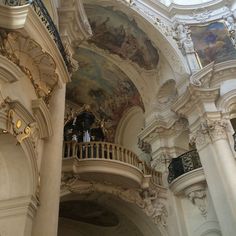 the interior of a building with paintings on the walls and ceiling, including a balcony